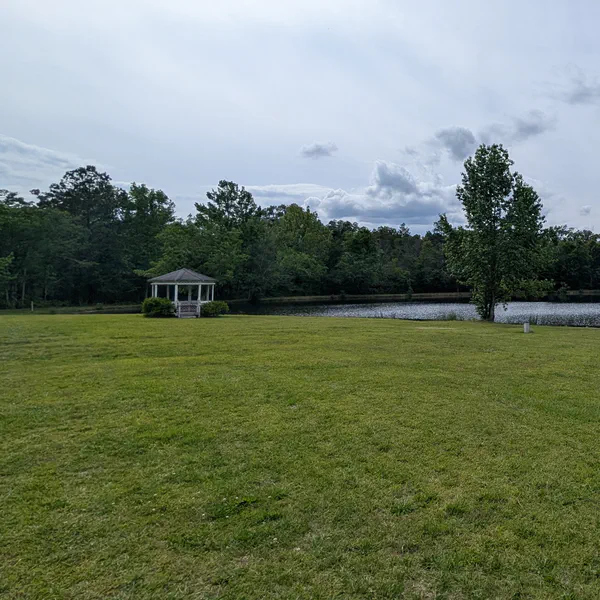 Looking across the field toward the pond. The gazebo sits at left.